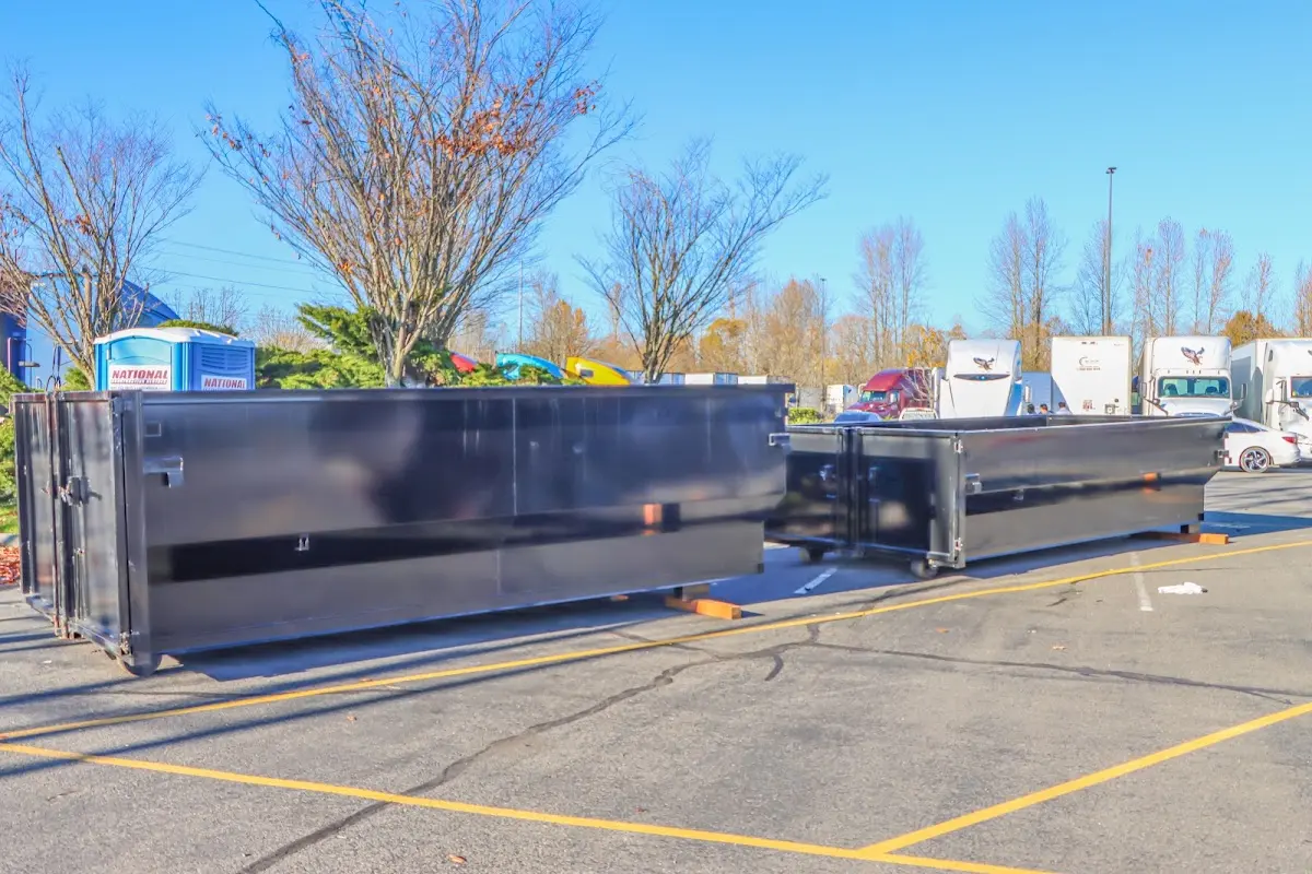 Professional dumpster rental service with roll-off container on residential driveway in Kewanee